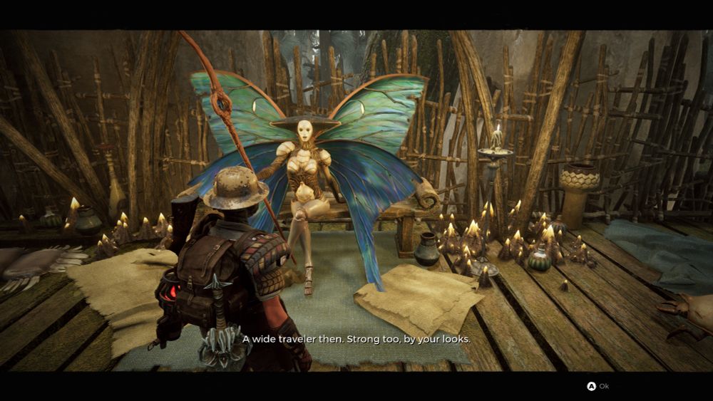 Meeting the Iskal Queen, who at first glance seems to be a rather attractive looking insect lady with large turquoise butterfly-type wings.