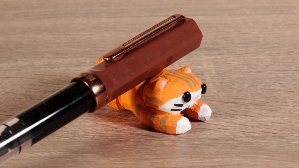 Handmade wooden tabby cat. Used as a fountain pen rest. #art #handmade #journaling #stationery #woodworking