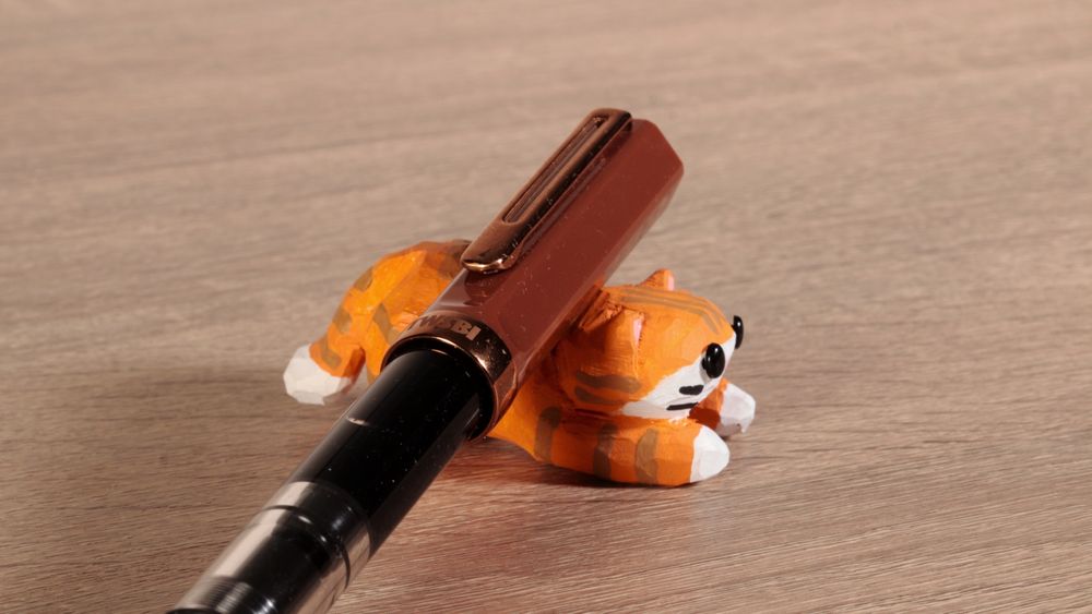 Handmade wooden tabby cat. Used as a fountain pen rest. #art #handmade #journaling #stationery #woodworking