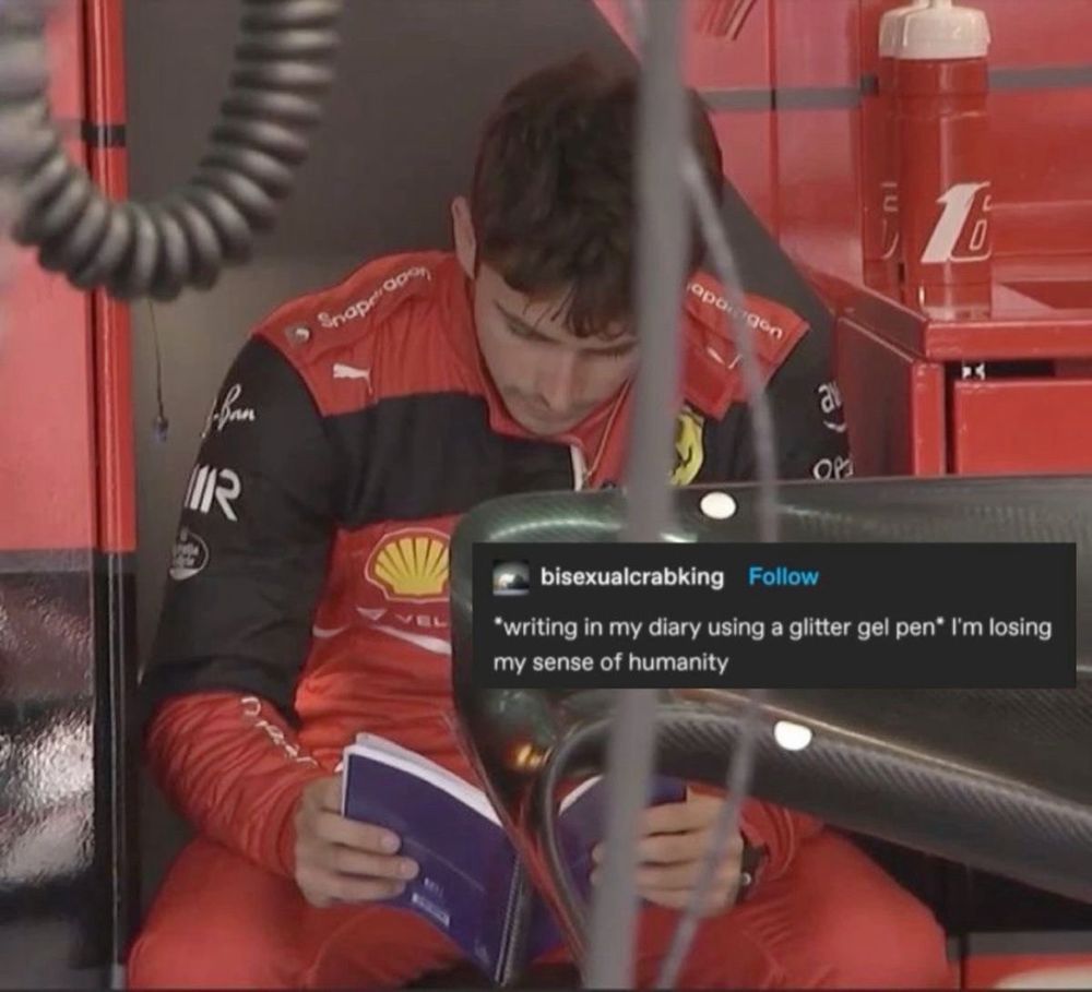 a photo of Charles leclerc reading?? A book?? In the ferrari garage with text over top:
*writing in my diary using a glitter gel pen* I'm losing my sense of humanity