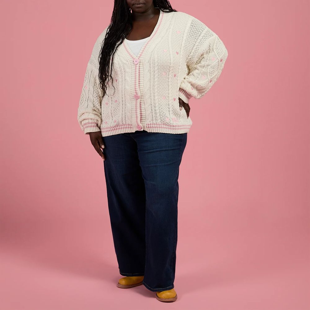 another model wearing the lover cardigan, this time with blue jeans and yellow shoes. 