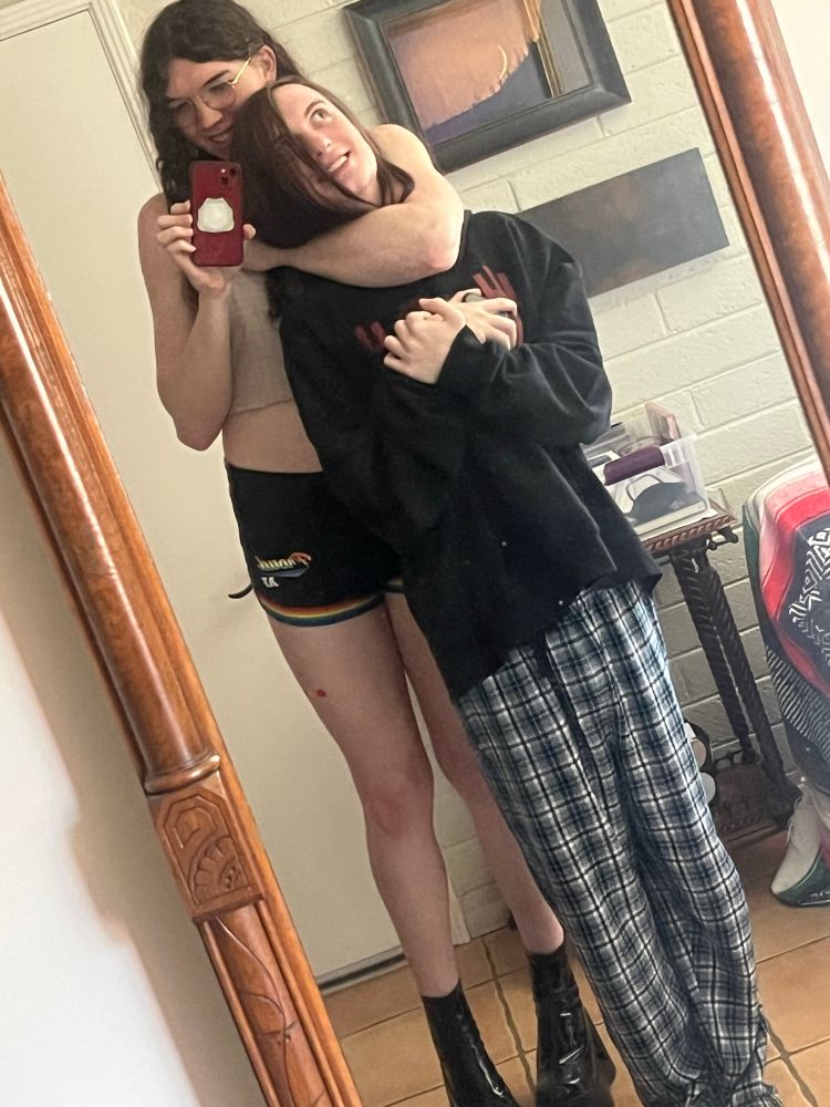 puddle in 5 inch platforms, standing behind scylla with her arm around her neck