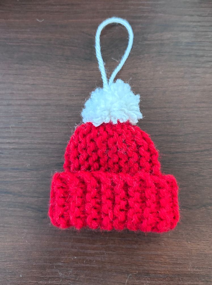 Mini red crocheted hat ornament with white pompom 