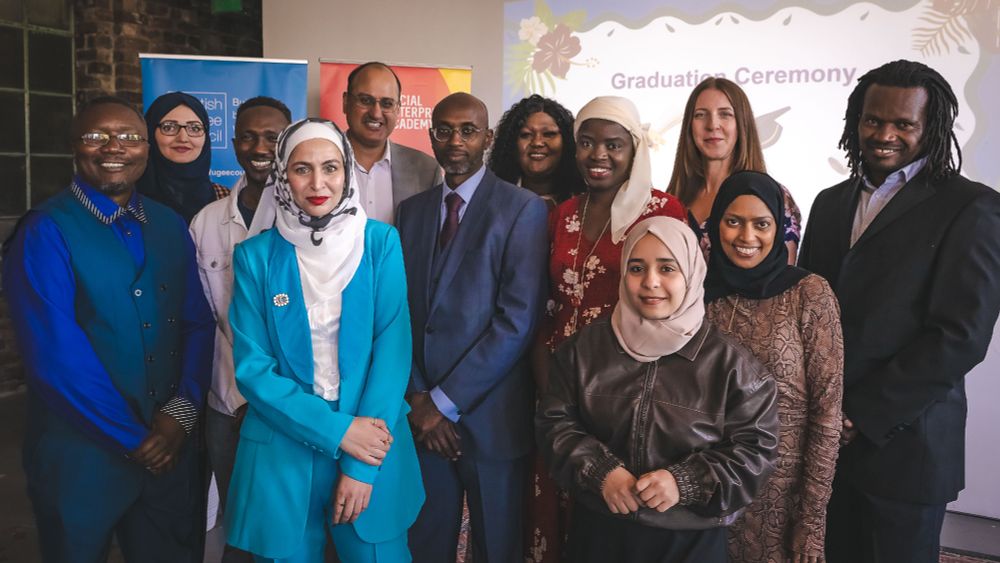 Group photo of the 2025 New Scots Leadership Programme graduates smiling and dressed to impress