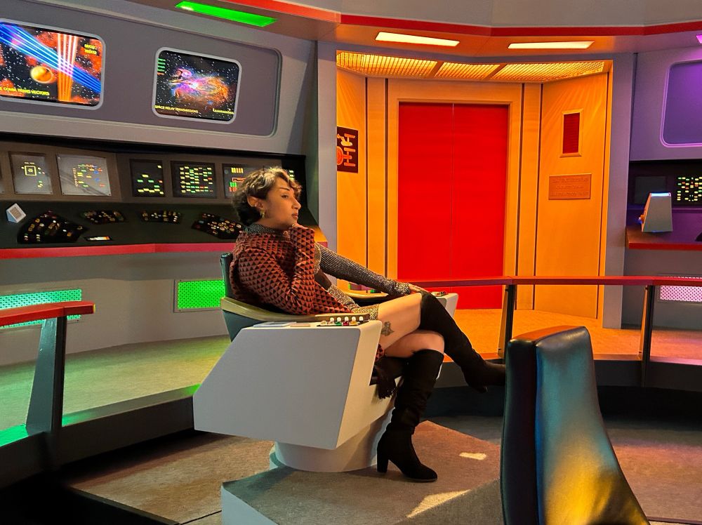The set of Star Trek tos bridge. I’m sitting in the Captain chair wearing a Romulan uniform