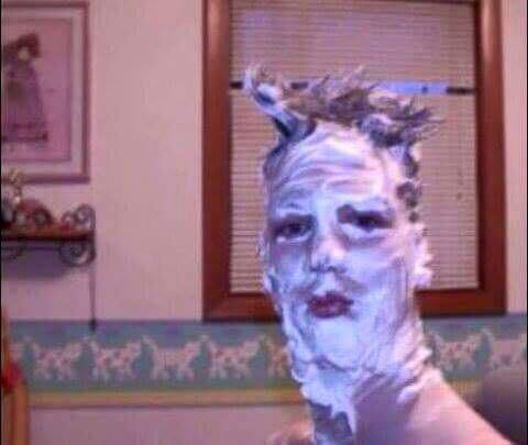 Image of a man with shaving cream smeared all over his face