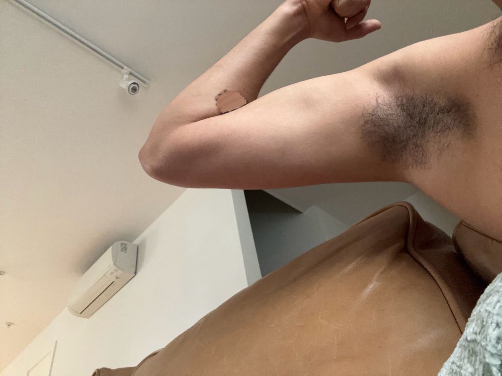 Showing off hairy pits that smell of a sweet umami body odor 