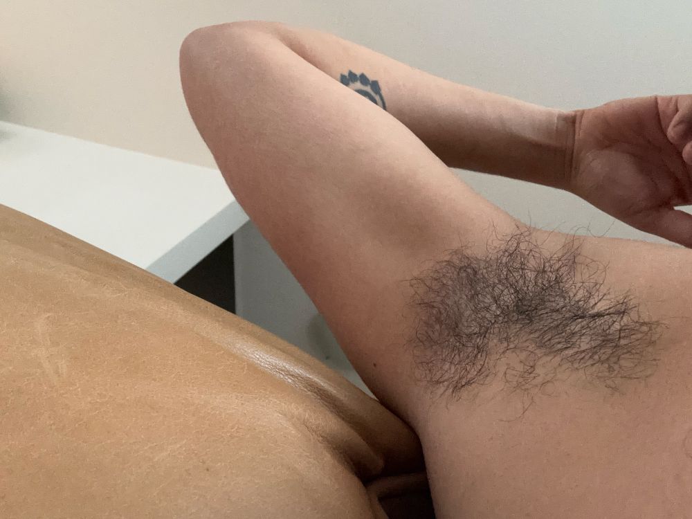 Showing off hairy pits that smell of a sweet umami body odor 