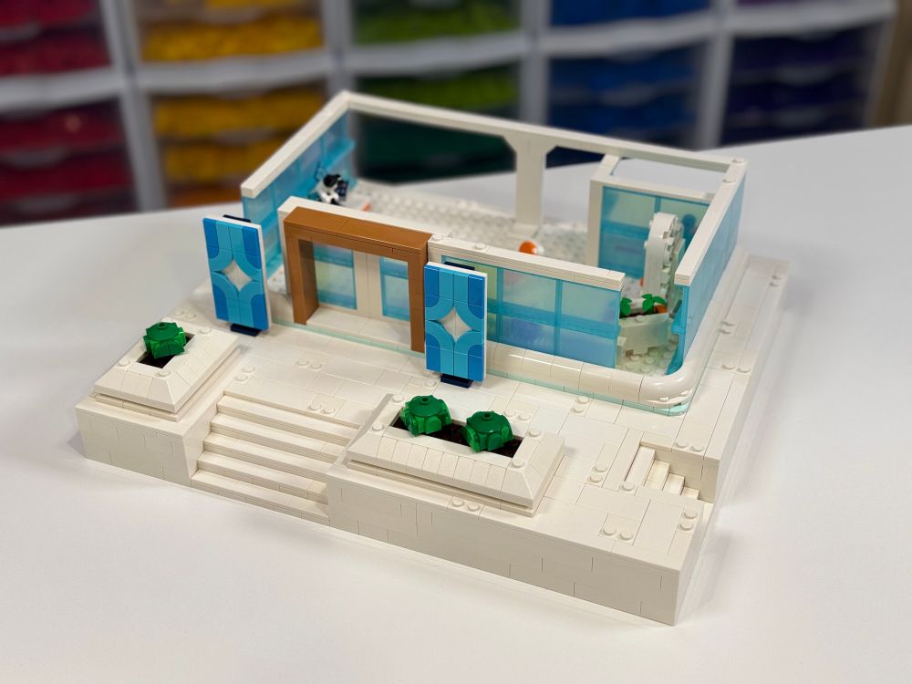 Physical build of a LEGO Fortnite Supernova Academy building, only partially completed with a base and the first floor.