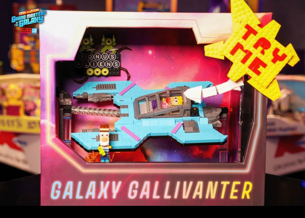 A lego built blue spaceship with purple accents inside a toy box called the Galaxy Gallivanter.
