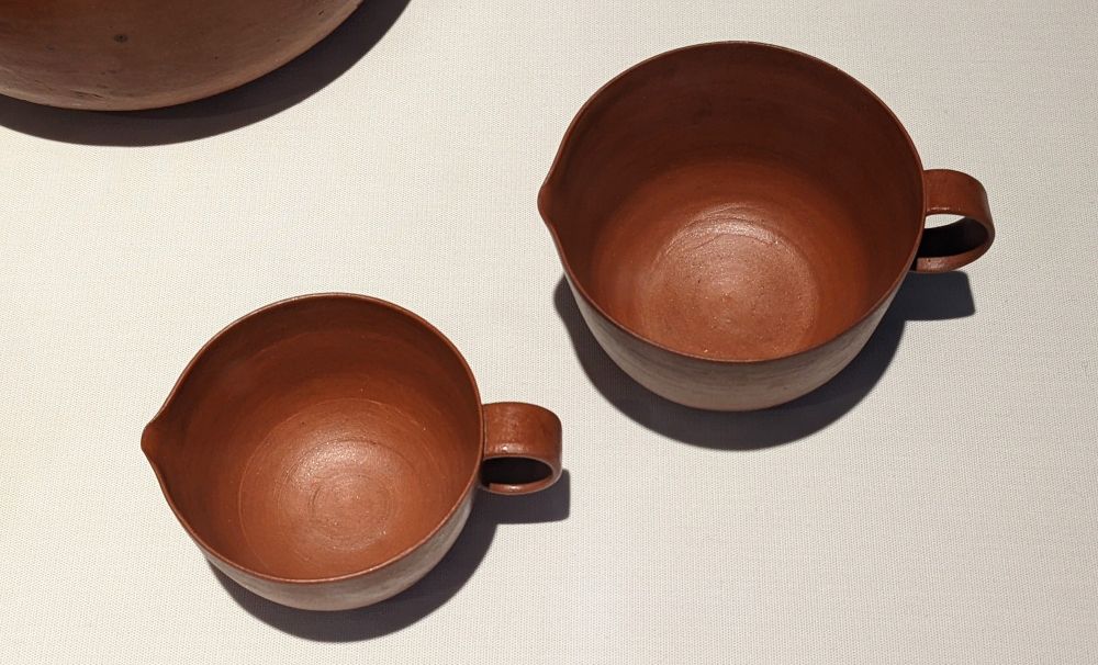 Thrown, burnished terracotta jugs. By Lucie Rie.