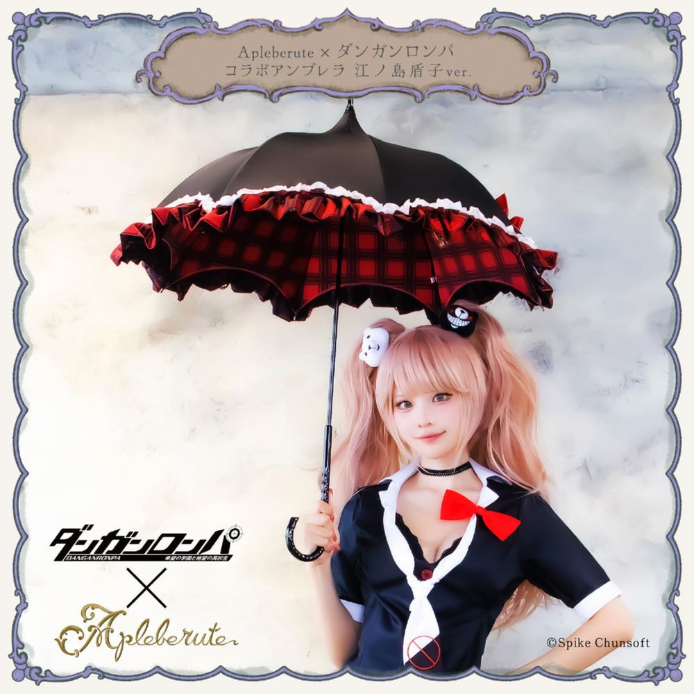 A model dressed as Junko from Danganronpa holding a black parasol with white lace and a red tartan-like pattern on the underside.