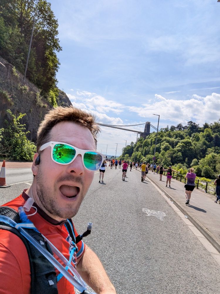 Selfie of me running the half marathon with the Clifton suspension bridge in the background