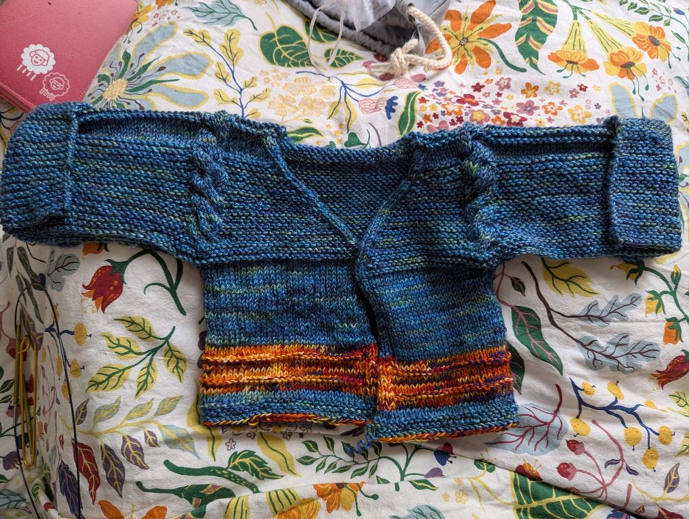 Completed, with red/purple/yellow/orange stripe in lower body. 