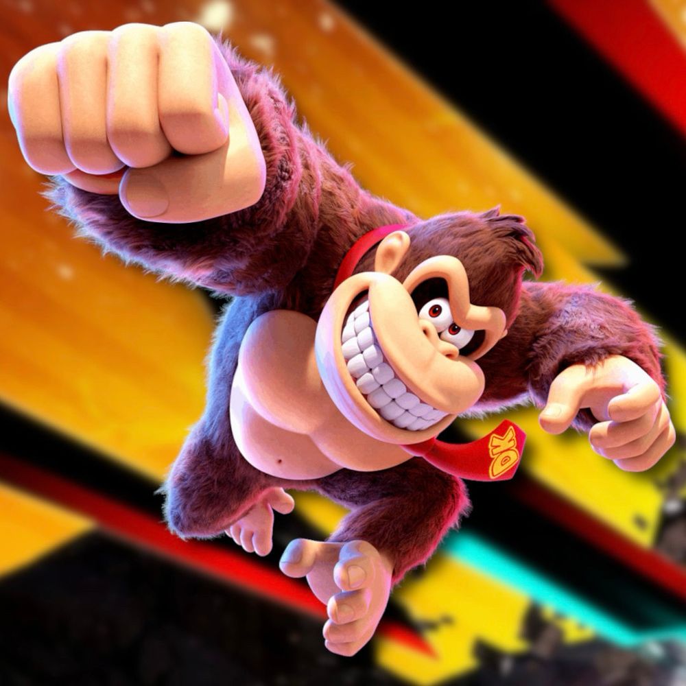 Image promotionnelle de Donkey Kong Bananza. Donkey Kong saute poing vers le haut en souriant.