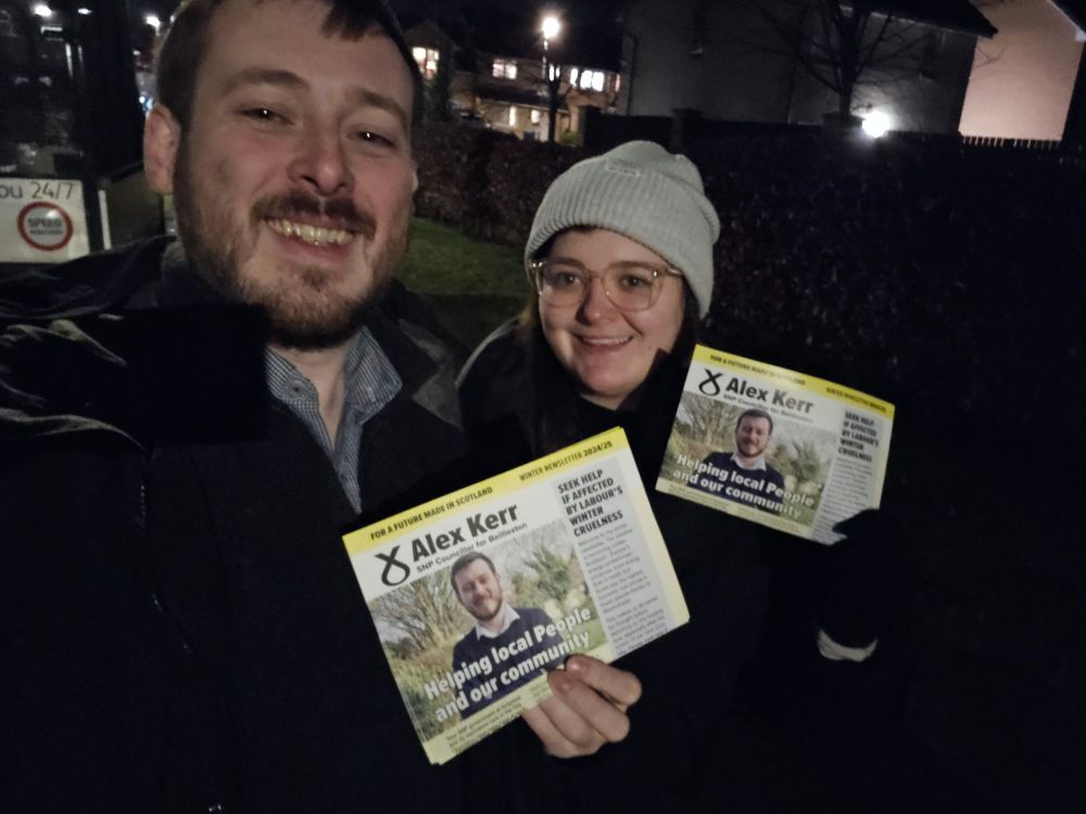 Alex Kerr and Emma delivering leaflets at night 