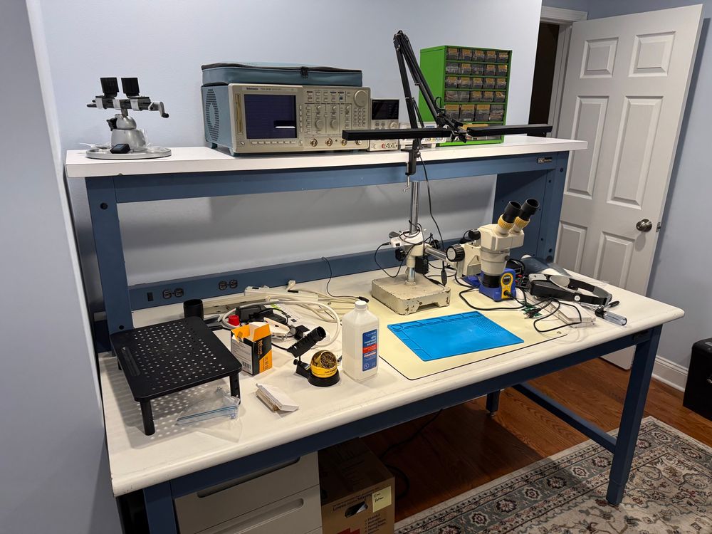 Picture of a cluttered electronics workbench