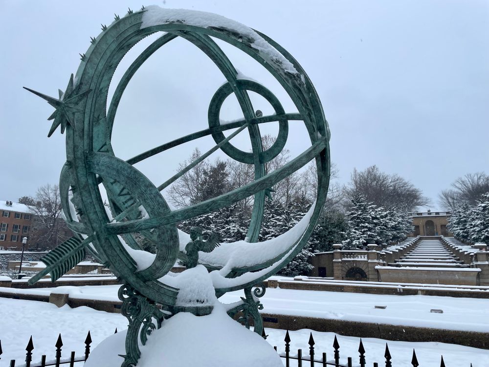 A photo of the armillary sphere on a snowy day 