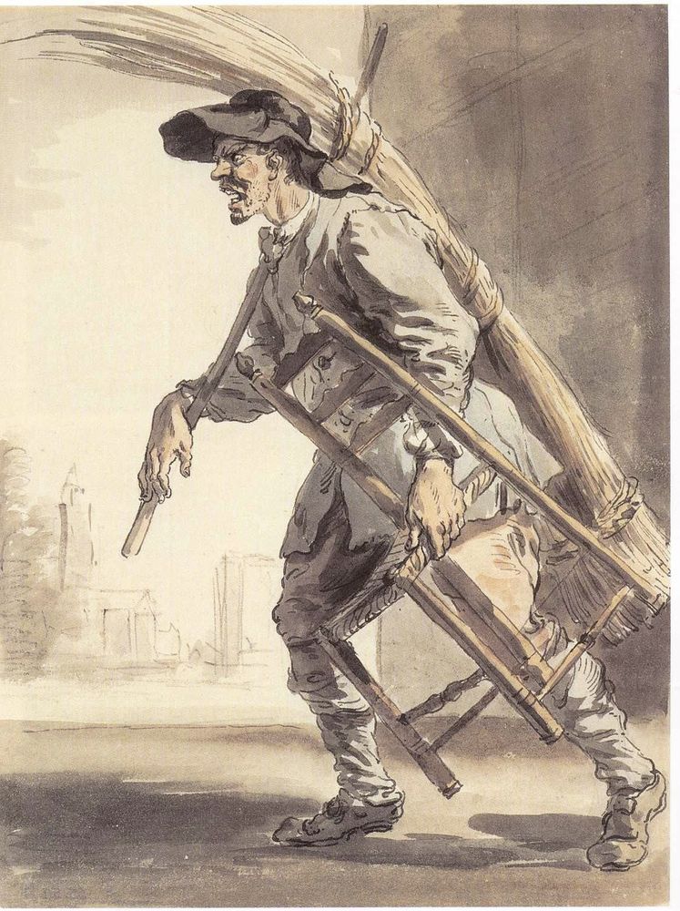 A man walks from right to left. He is wearing a floppy black hat, and a grey coat and trousers. In his left hand is a chair with a rush seat, and in his right hand is a poll resting on his right shoulder, which holds a quiver of rush at his back.