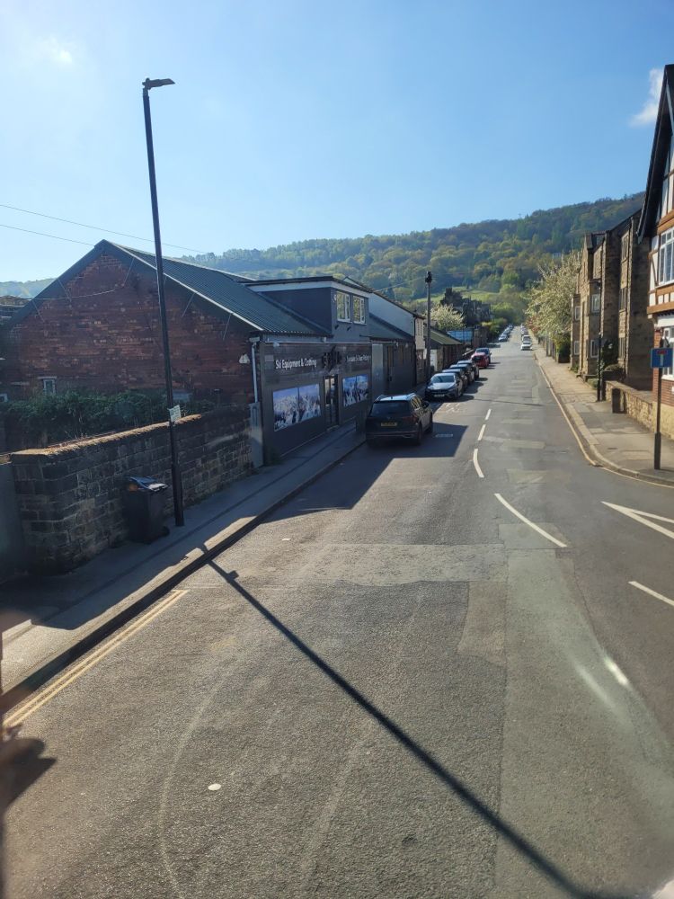 Road narrowing into the distance with hills behind