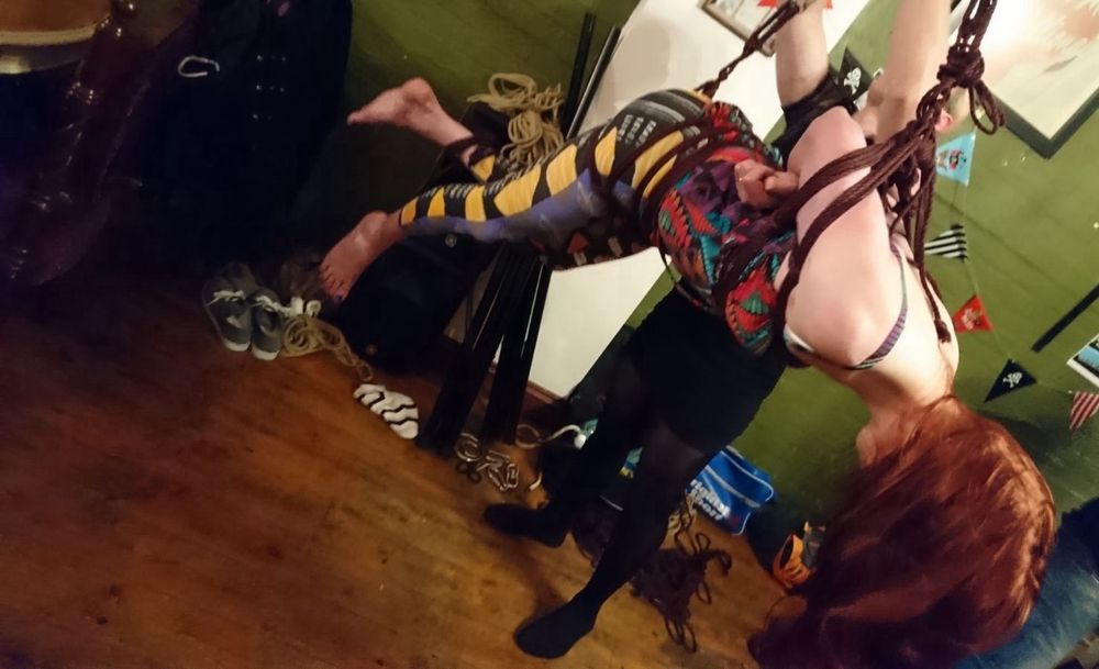 Red headed Girl suspended in rope shibari 