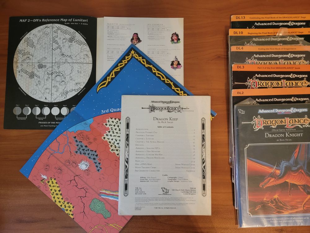 Dragon Keep adventure module is here with the cover off (intended), with a map showing some of the surface of the Red Mood of Lunitari. Other modules are nearby in an attractive stack.