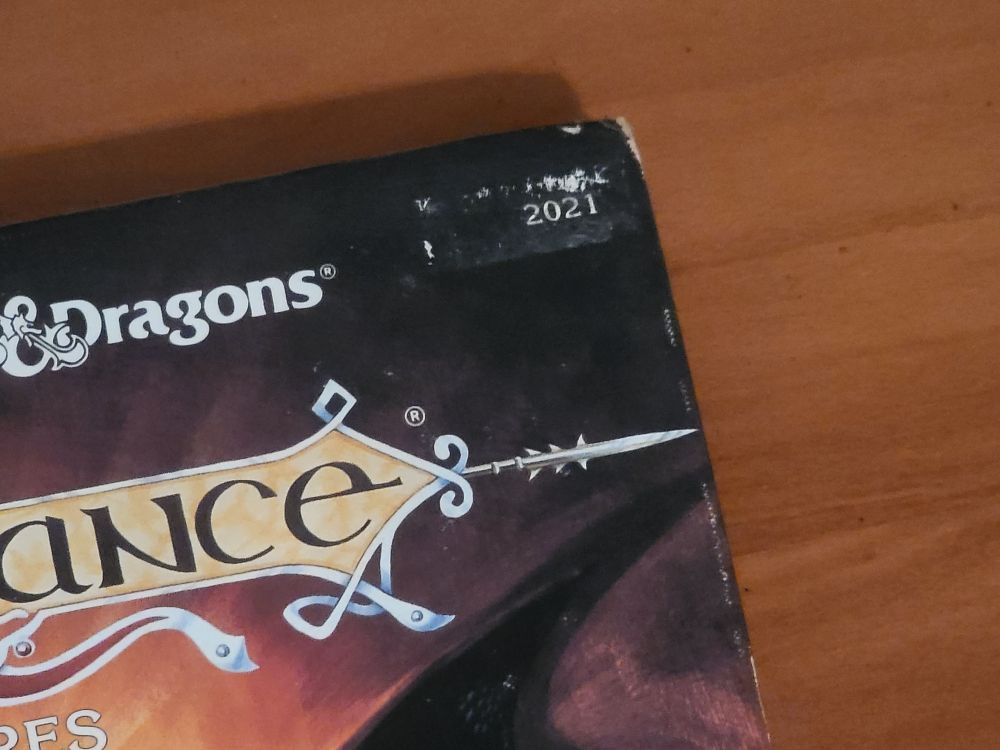 Detail of the top right corner of the AD&D Dragonlance Adventures book, showing, the 2021 sticker that's some kind of book part number.