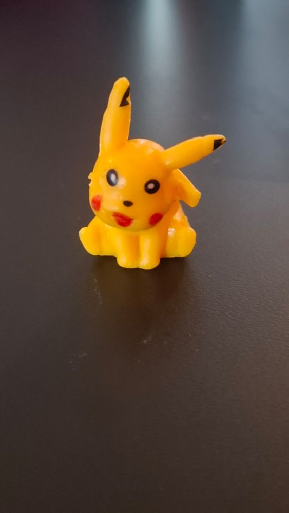 A very badly molded plastic toy of Pikachu. it looks extremely wonky.