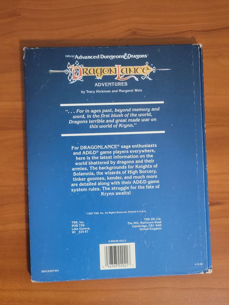 AD&D Dragonlance Adventures back cover. Back cover text begins with: "For DRAGONLANCE saga enthusiasts and AD&D game players everywhere, here is the latest information on the world shattered by dragons and their armies". Also prices and barcodes.