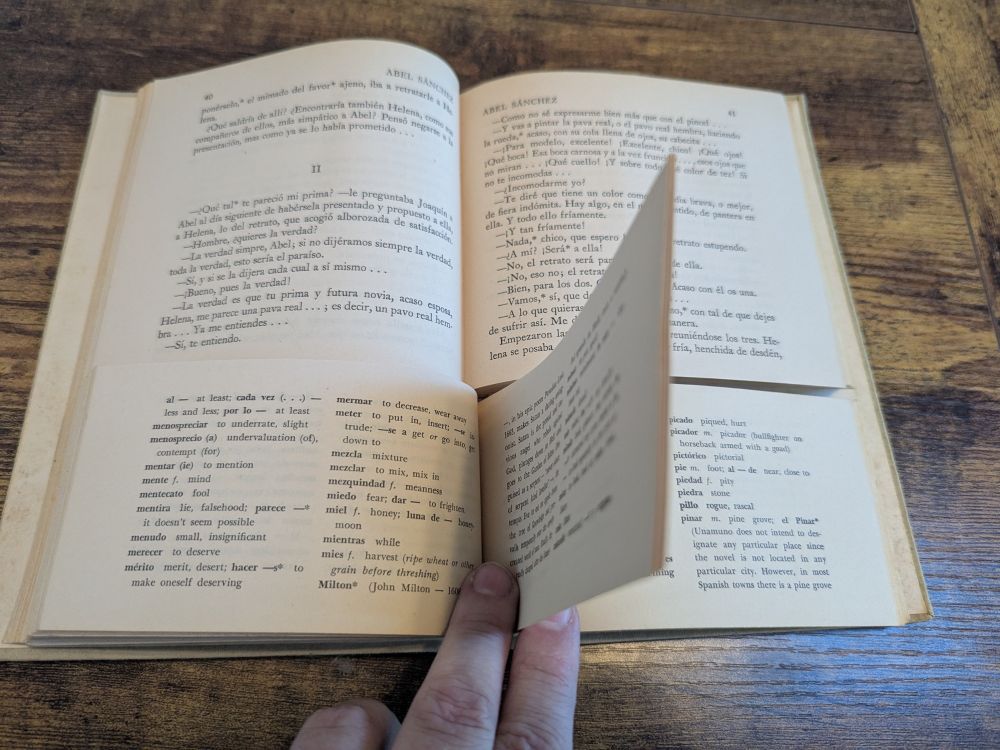 same book, open. the top 2/3 of the book is the story proper. The bottom third of the book is the glossary. I am turning the pages of the book to demonstrate that the second bottom half of the book is its own book whose pages can be turned independently.