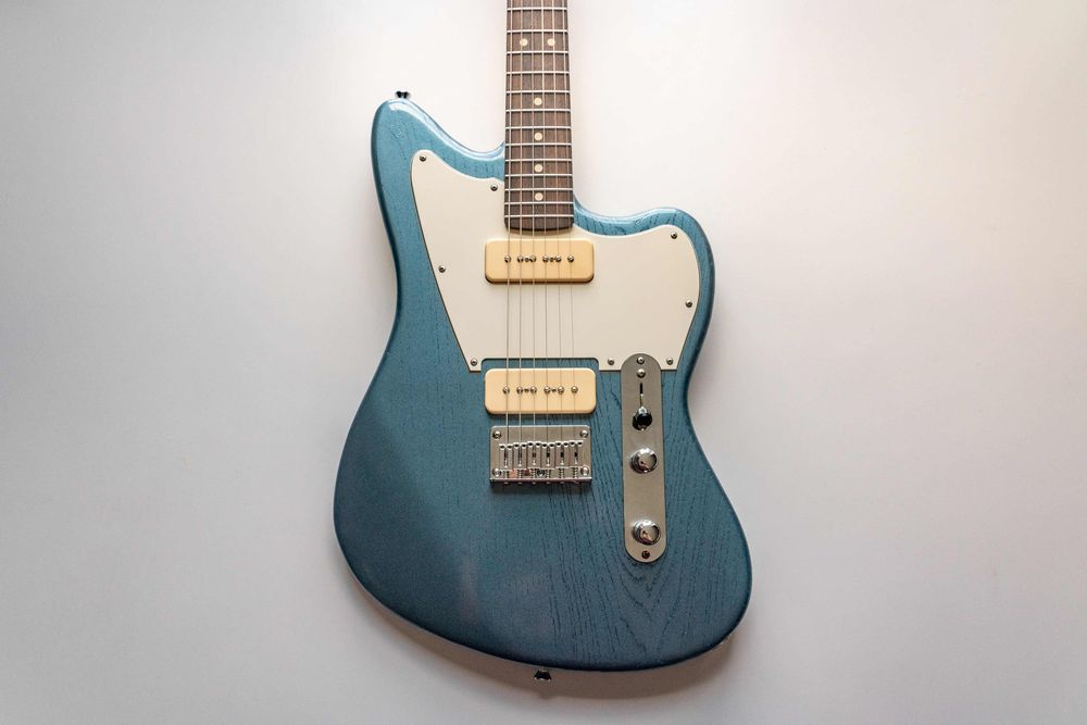 A teal blue offset electric guitar. 