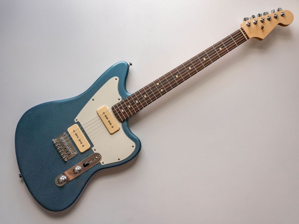 A teal blue offset electric guitar. 