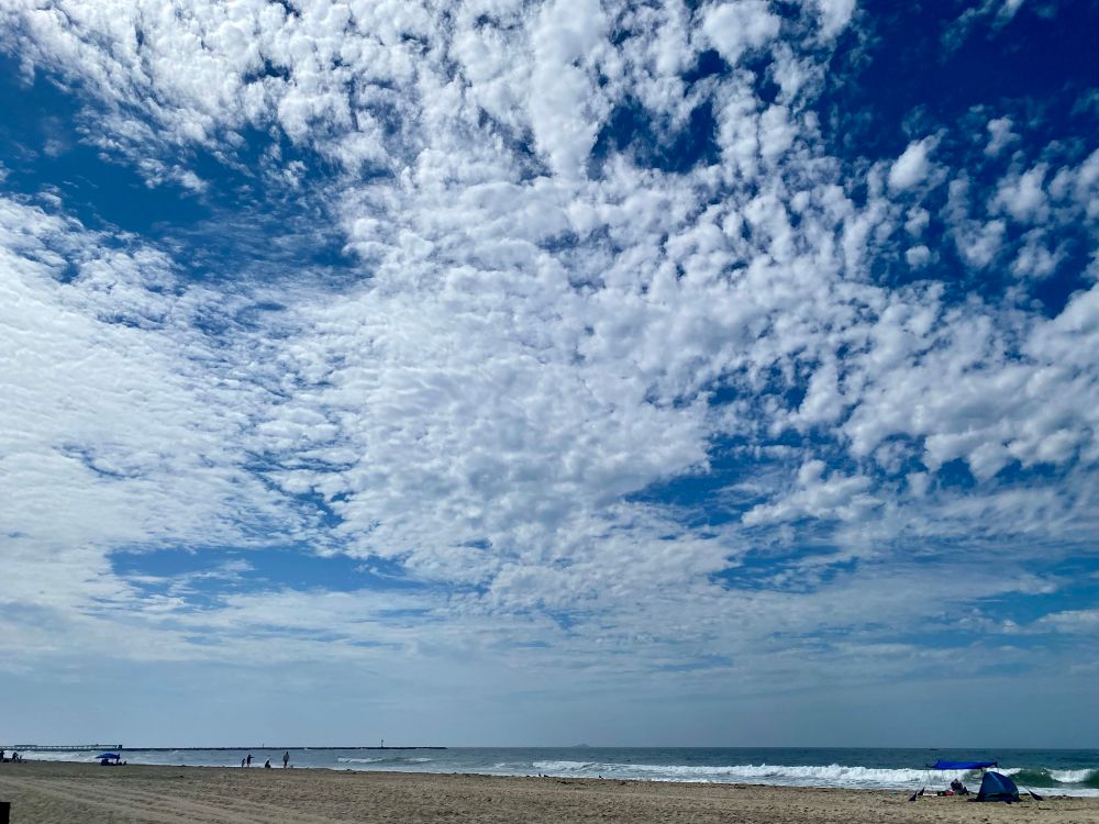 Coast with clouds and beach tent. 