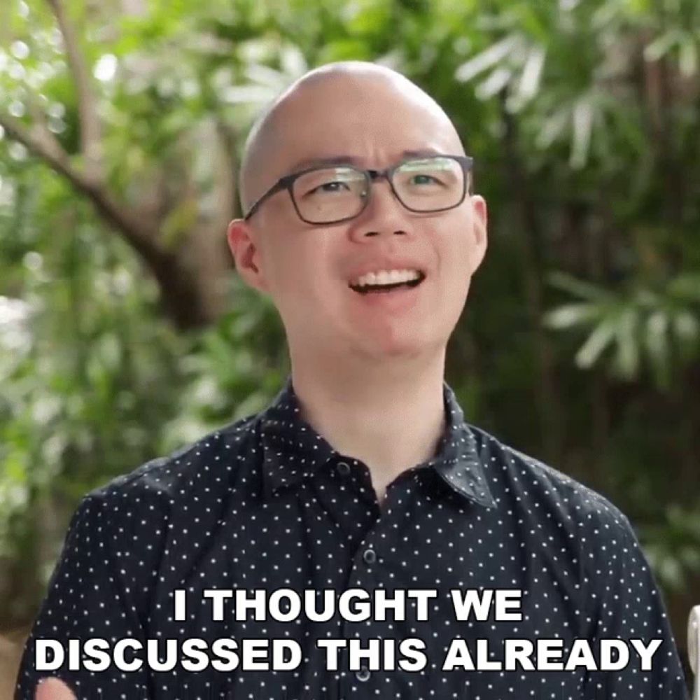 a bald man wearing glasses and a polka dot shirt says i thought we discussed this already