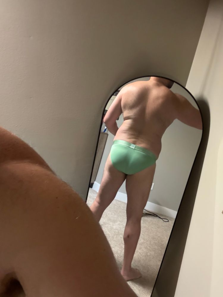 Man in mirror wearing wintergreen briefs. 