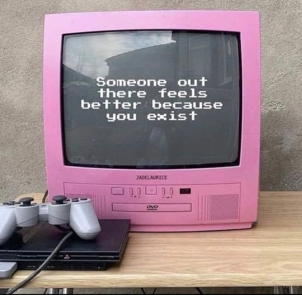 A pink television/DVD player combo with a black screen. The text on the screen reads, "Someone out there feels better because you exist."