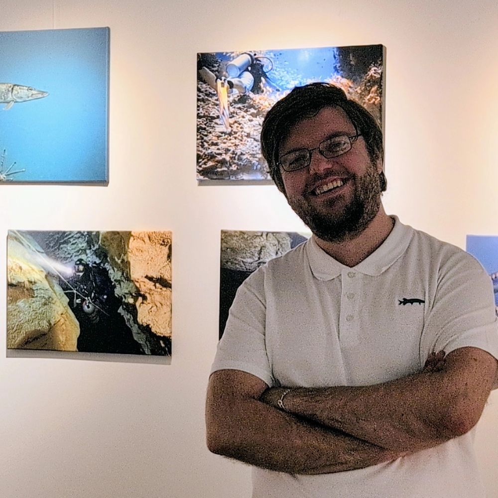 Me in front of the photos I exhibit at the Unterwasserfestival in Zurich, smiling 