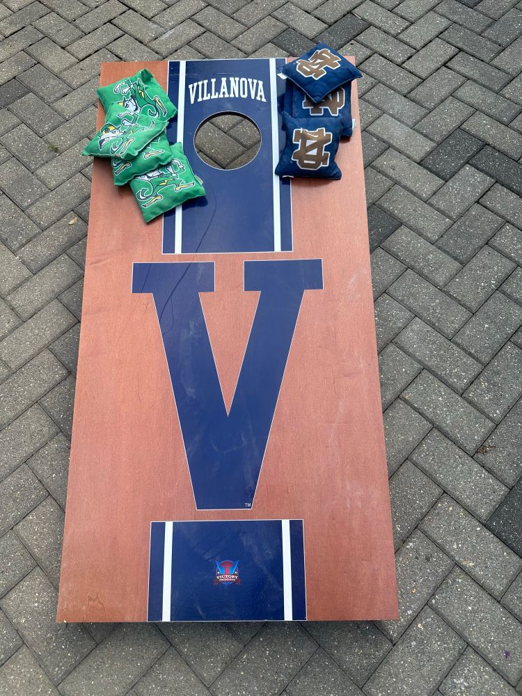 Villanova cornhole boards with Notre Dame leprechaun and monogram bags.