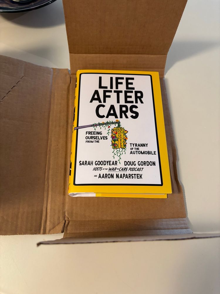 The book “Life After Cars” in its shipping sleeve.