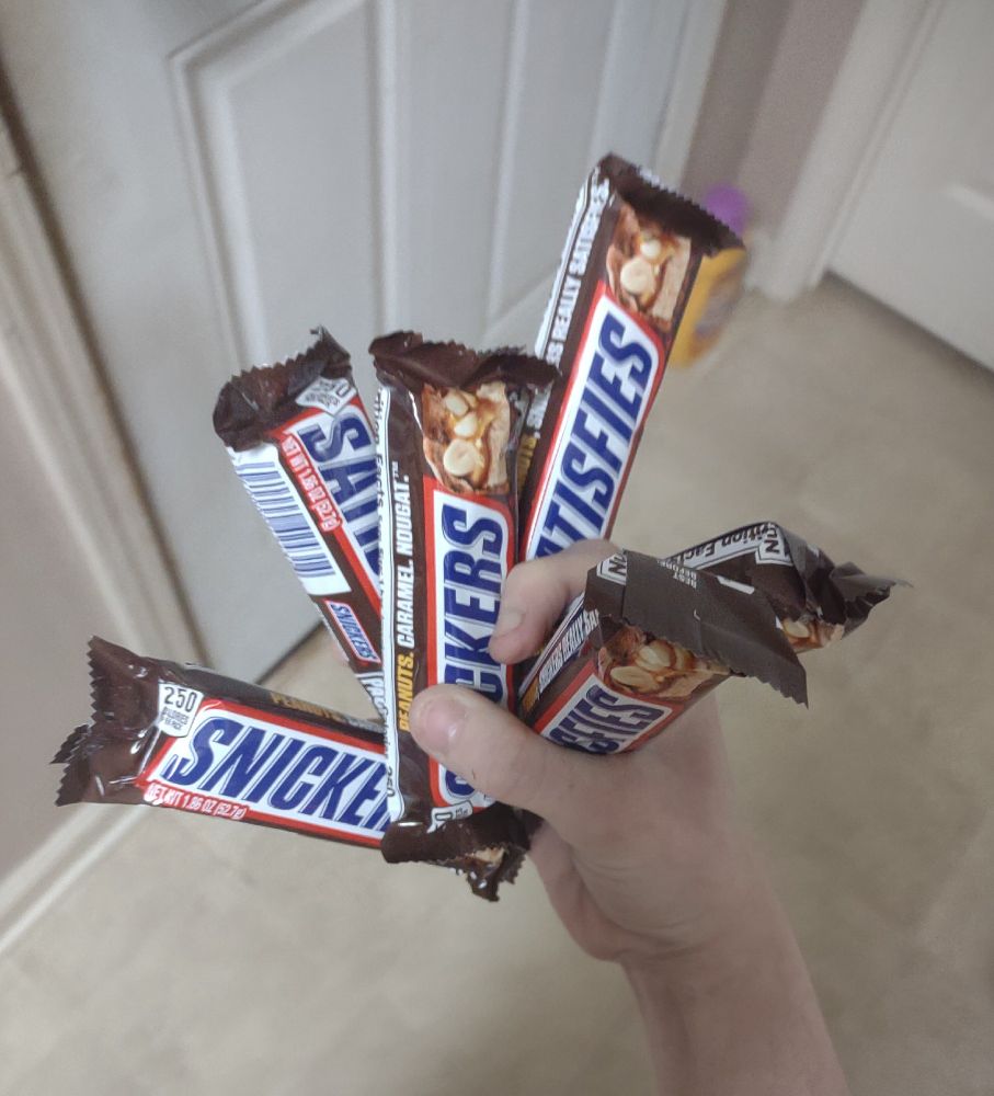 A bunch of snickers bars in my hand