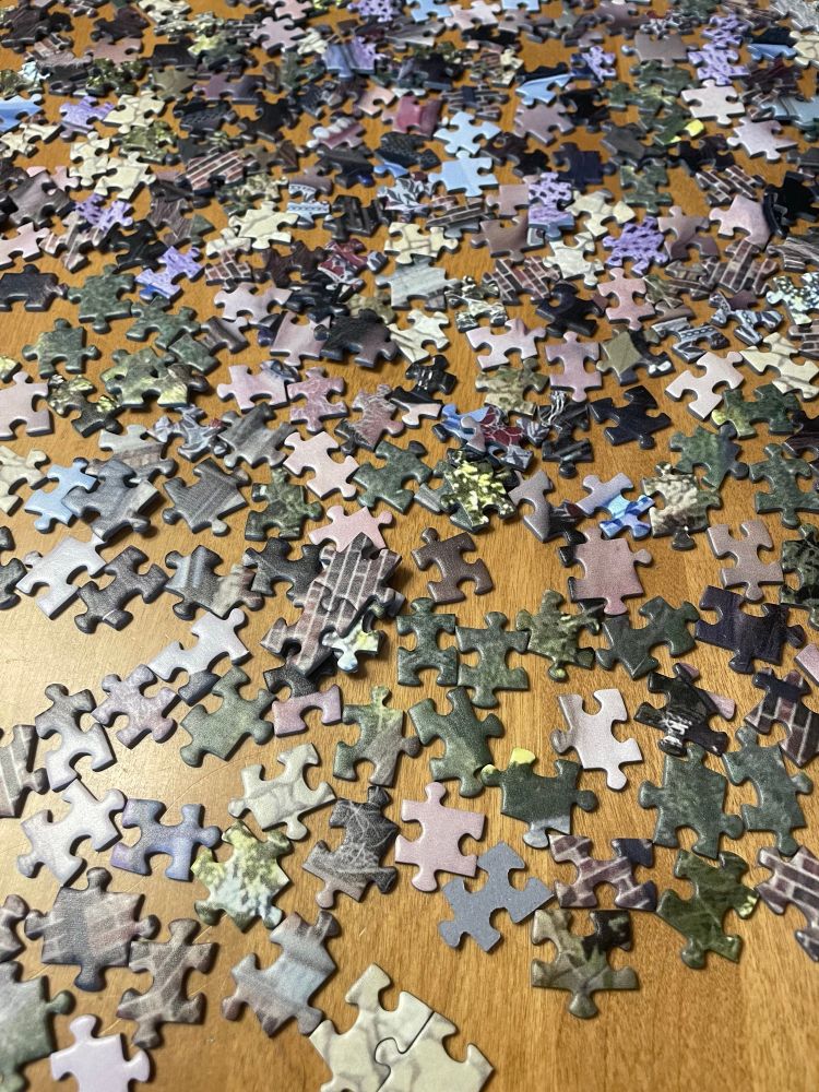 Puzzle pieces scattered on table 