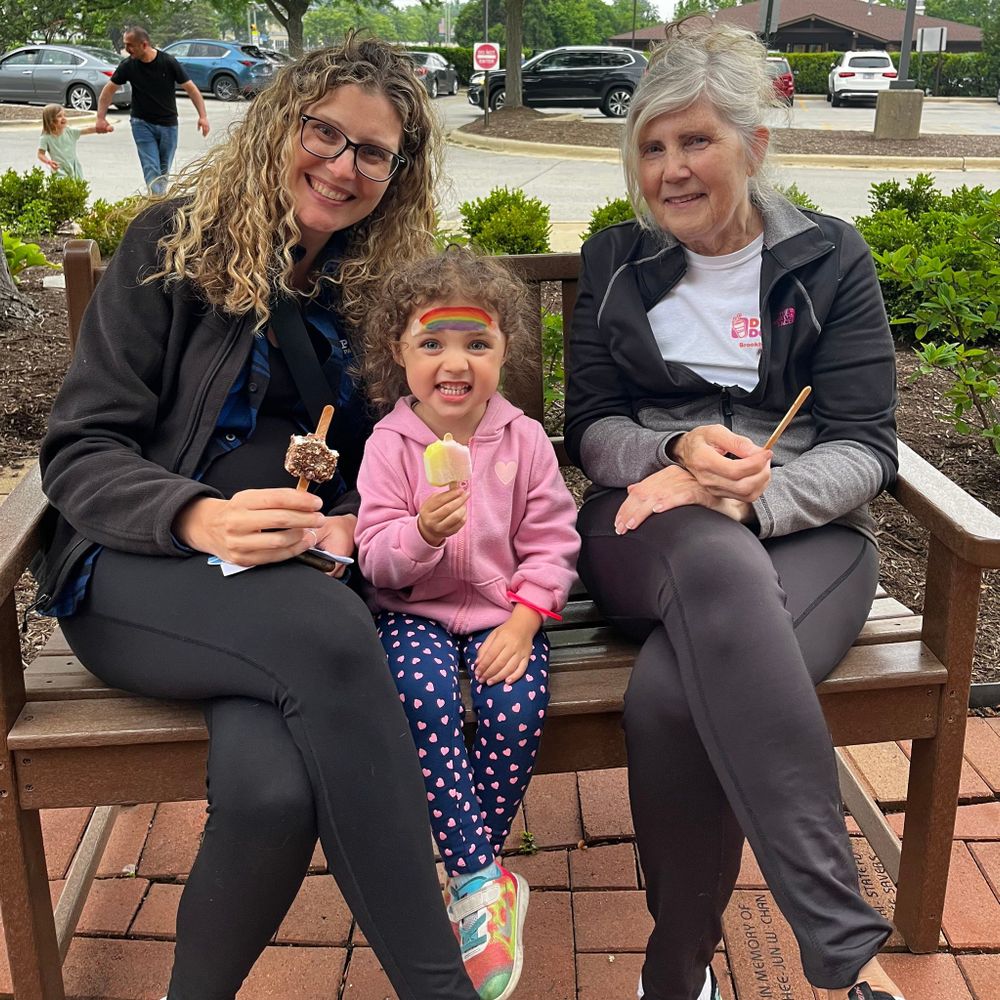 Mom, daughter, and grandma sitting and enjoying ice cream.