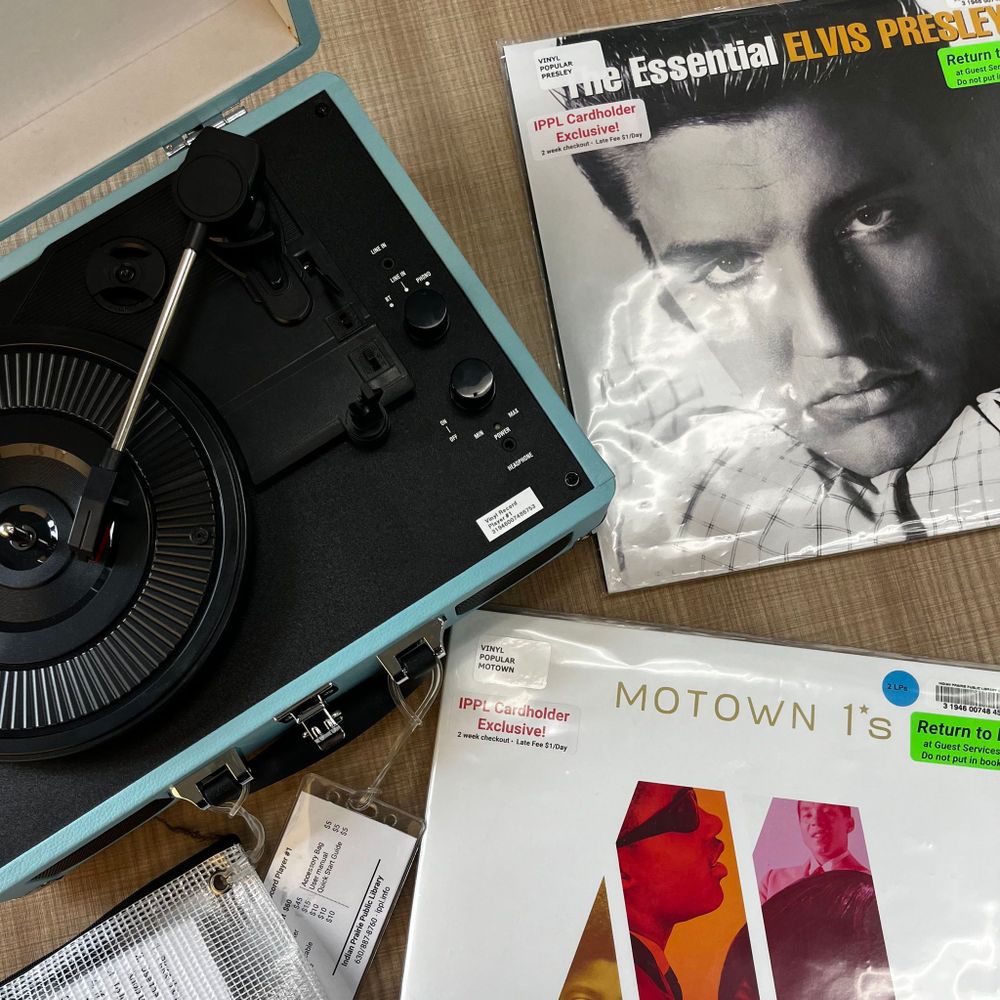 A vinyl player and two records.