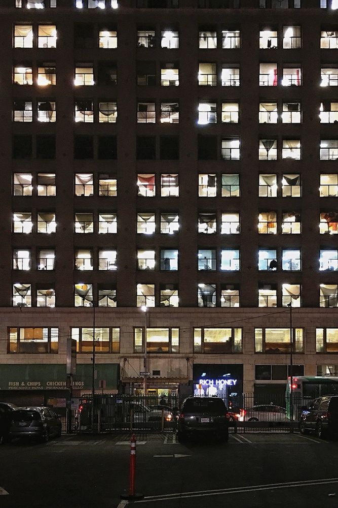 A wall of windows illuminated from within at night