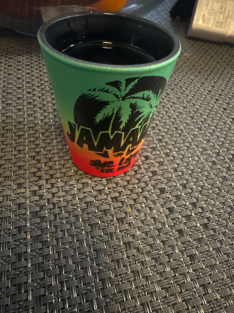 Tequila in a Jamaican shot glass. 