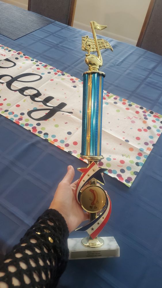 This is a trophy with an anthropomorphic hot dog commemorating hot dog contest victory. 