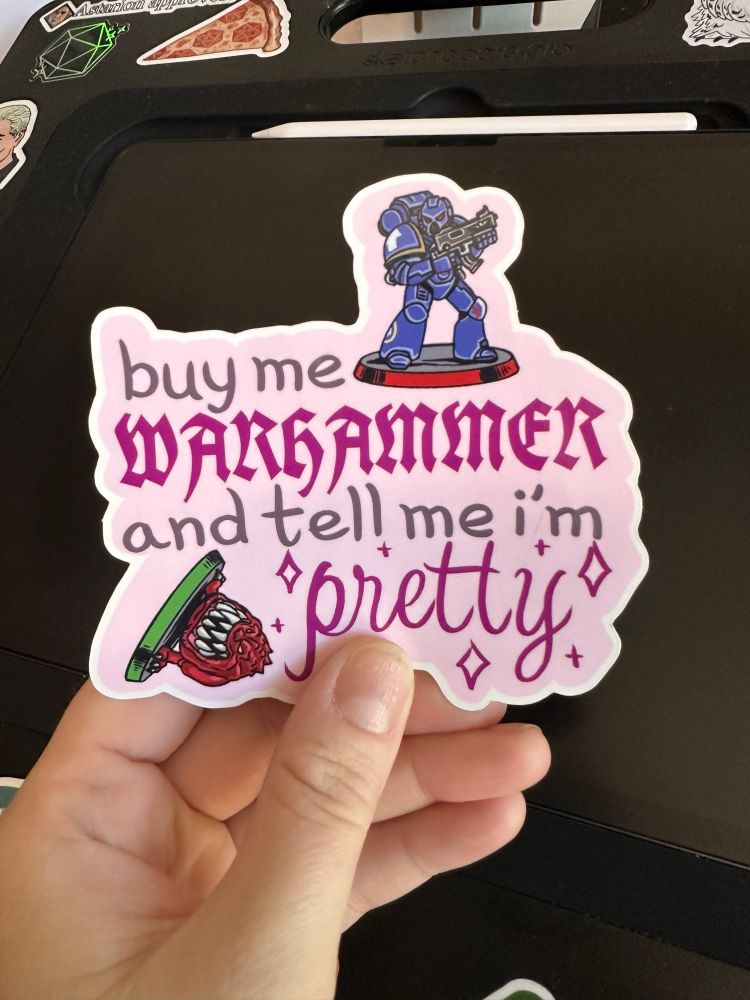 A sticker which reads “buy me Warhammer and tell me I’m pretty” 