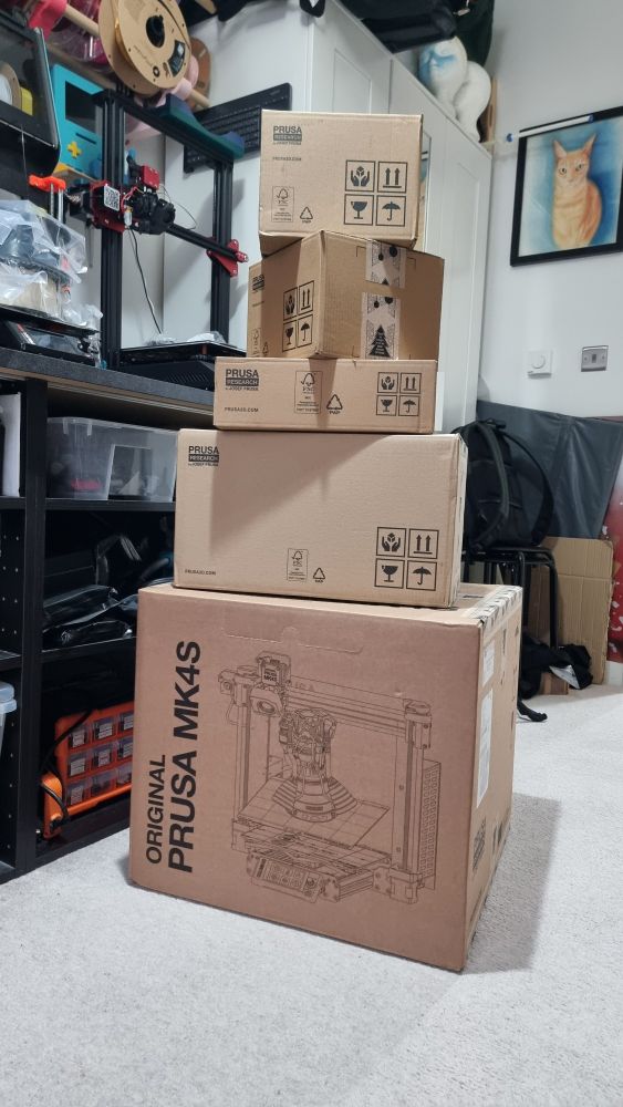 Tall stack of boxes from Prusa Research including the Prusa MK4S. 