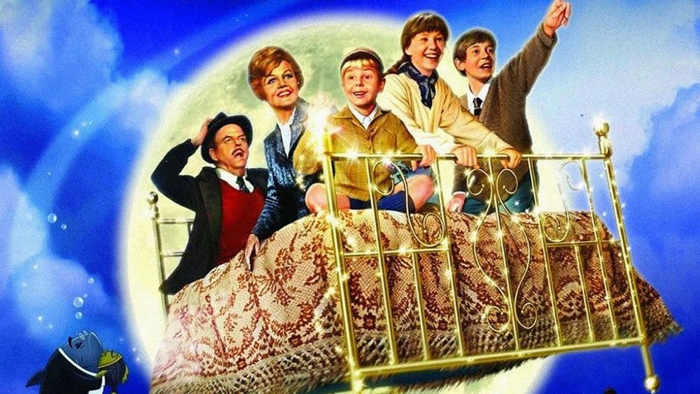 Promotional image from 1971 movie "Bedknobs and Broomsticks"
The image shows three orphans from London with their country foster in a flying bed with a reluctant passanger.
The actors are  Angela Lansbury, David Tomlinson, Ian Weighill, Cindy O'Callaghan, and Roy Snart.
