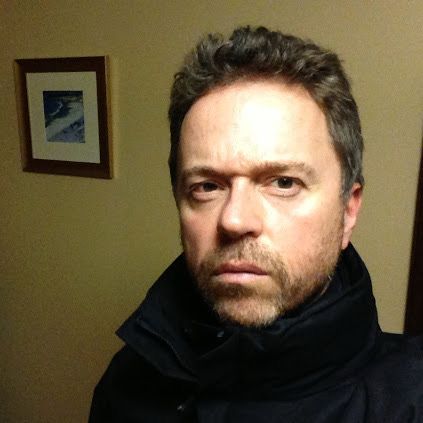 Divorced man with his coat collar turned up tries to look hard, succeeds in looking a berk.